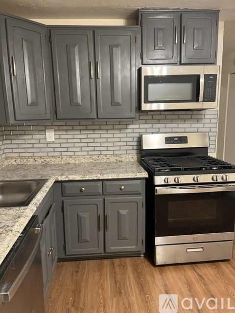 A kitchen with a stove and cabinets.