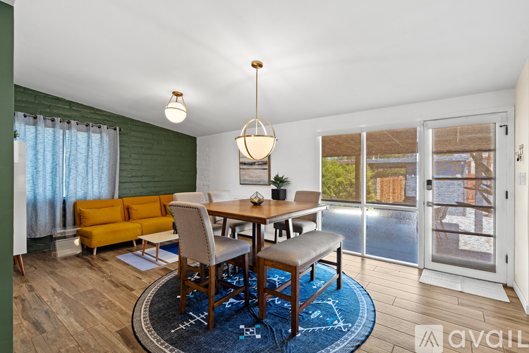 A dining room with a wooden table and chairs.