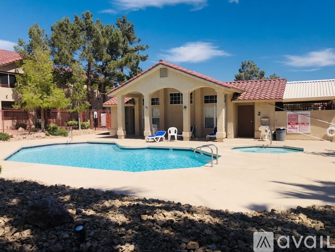 A house with a pool in front of it.