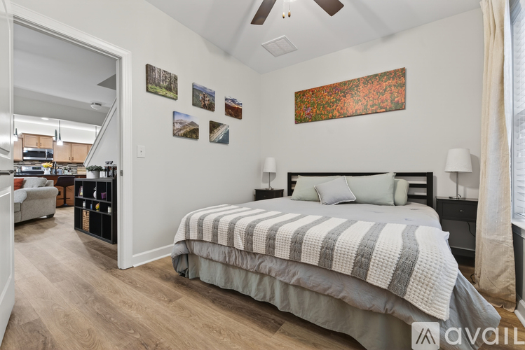 A bedroom with a large bed and a ceiling fan.