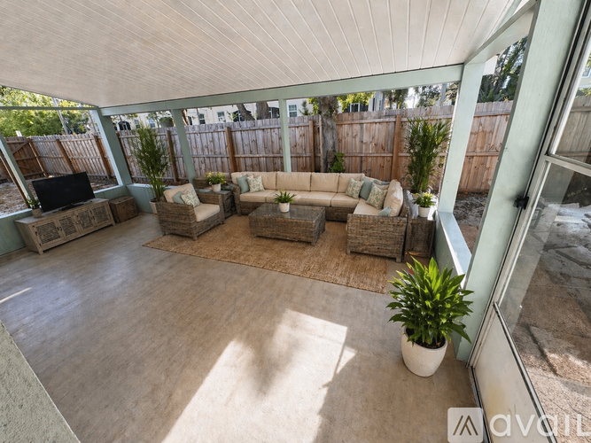 A patio with a white ceiling and a brown rug.