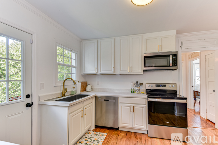A kitchen with white cabinets and stainless steel appliances.