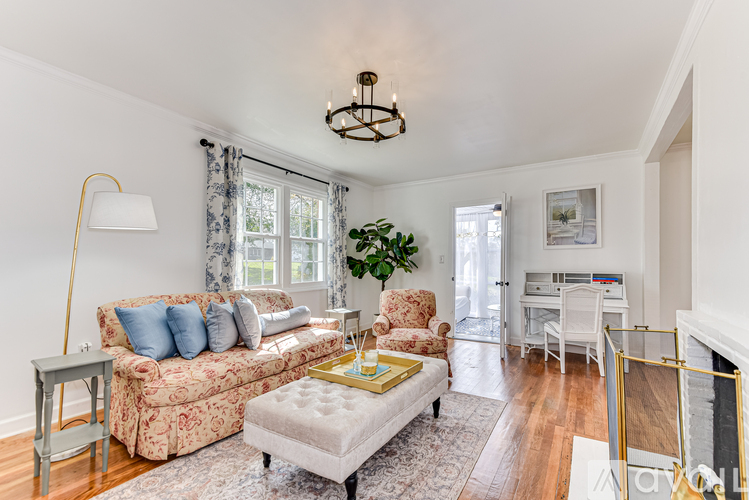 A living room with a couch, chair, and a table.