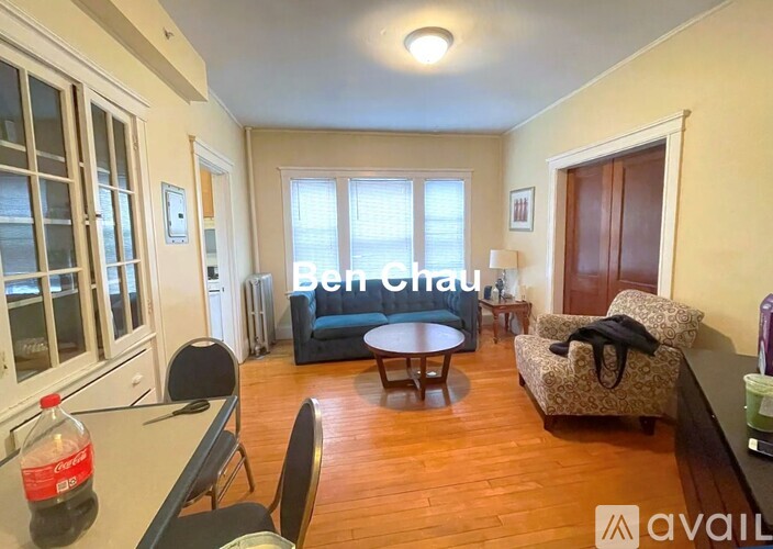 A living room with a sofa, a table, and a chair.