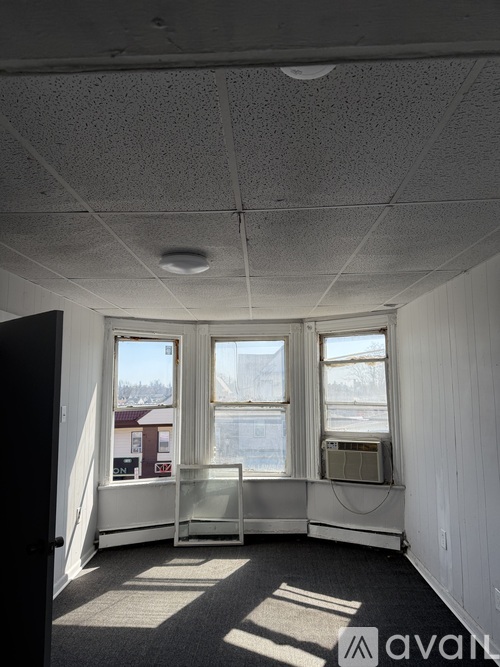 A room with a window overlooking a snowy landscape.