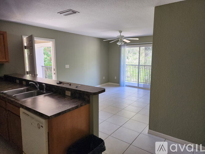 A kitchen with a dishwasher and a fan.