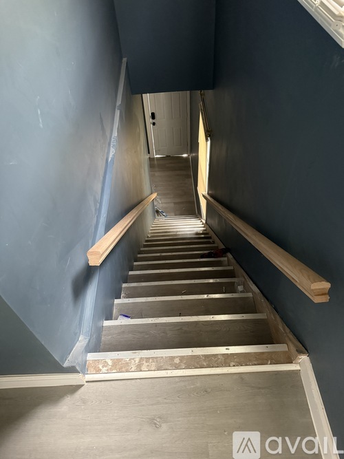 A staircase with wooden handrails and steps leading upwards.