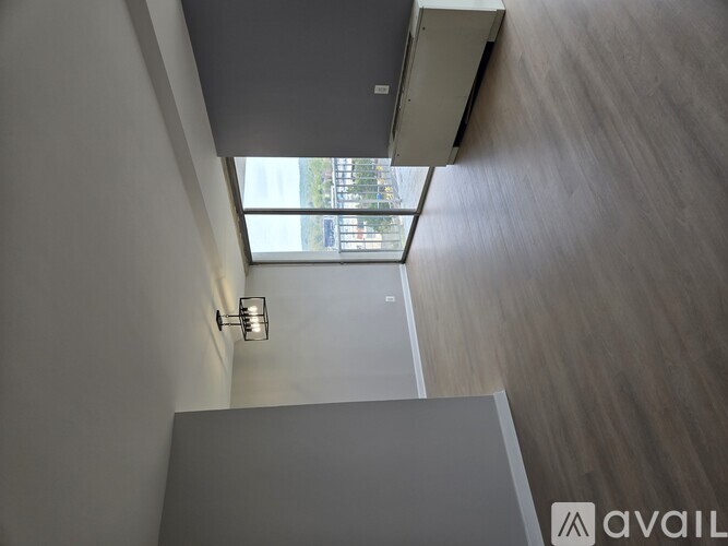 A modern interior with a skylight and a wooden floor.