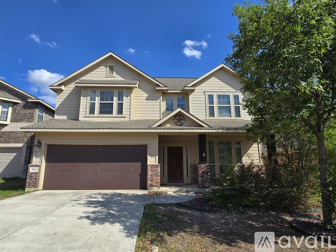 A two-story house with a garage is for sale.