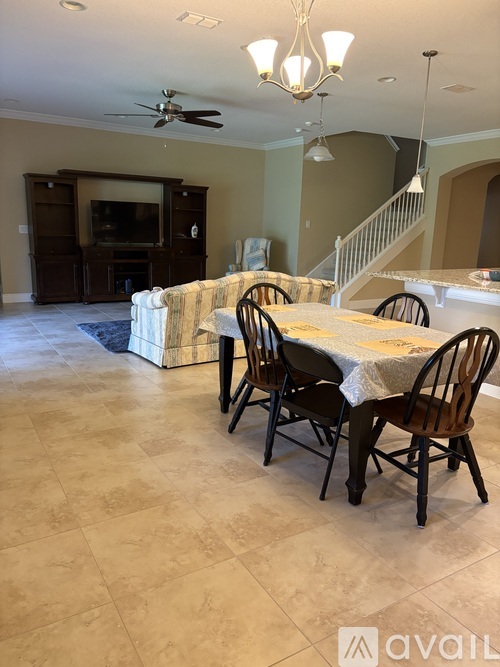 A dining room with a table set for six.