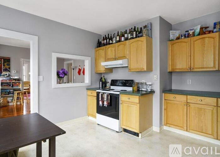 A kitchen with wooden cabinets and a black oven.