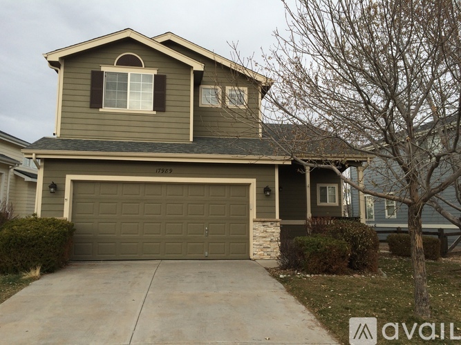 A house with a garage and a driveway in front.