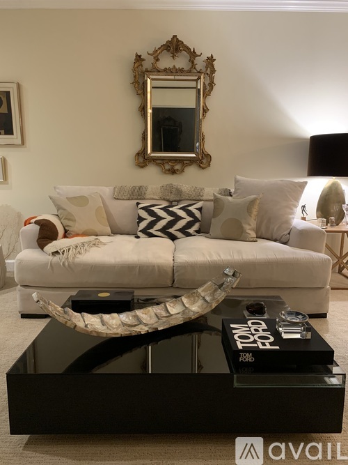 A living room with a white couch and a coffee table.