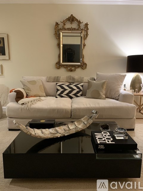 A living room with a white couch and a coffee table.