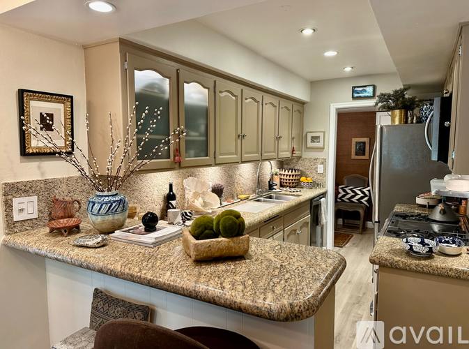 A kitchen with granite countertops and a view of the backyard.
