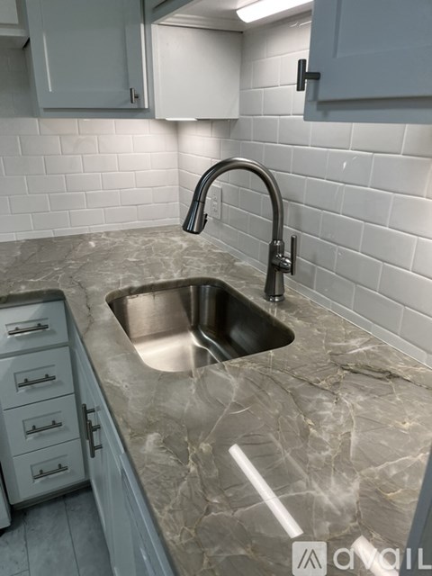 A kitchen with a sink and a countertop.