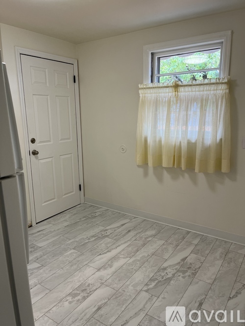 A room with a window and a door.