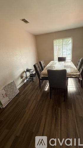 A dining room with a table and chairs.