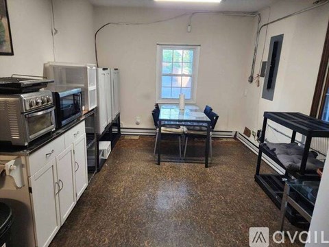 A kitchen with a table and chairs in the middle of the room.