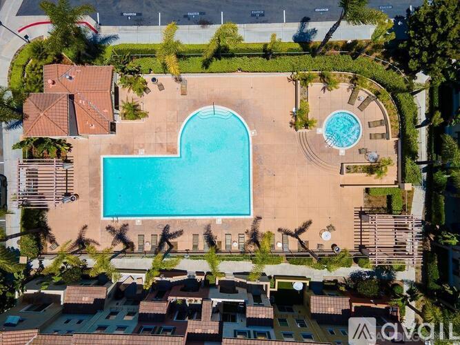 An aerial view of a swimming pool surrounded by a residential area.