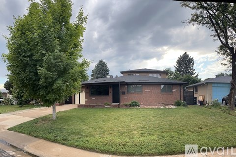 A house with a tree in front of it.