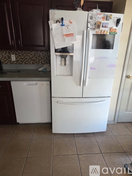 A white fridge with a lot of papers attached to it.