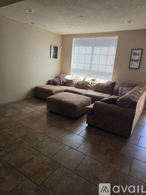 A living room with a large sectional sofa and a loveseat.