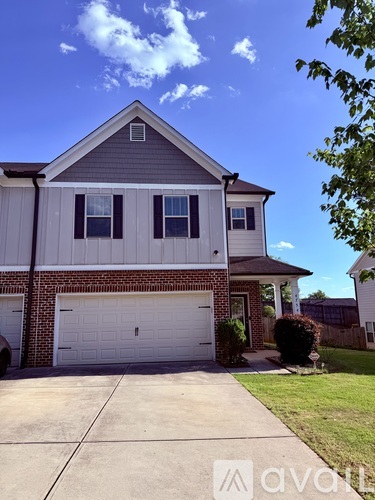 A two-story house with a garage is shown in the image.