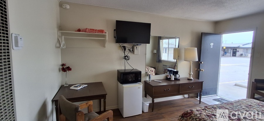 A bedroom with a bed, desk, and chair.