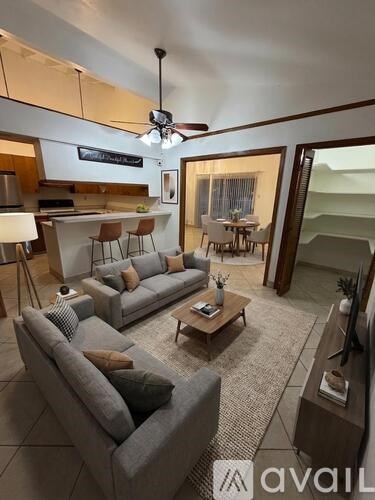 A living room with a grey couch and a television.