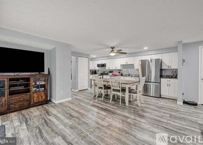 A well-lit kitchen with a dining table and chairs.