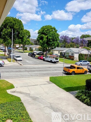 A yellow taxi is parked on the right side of the street.