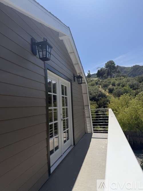A house with a balcony and a lamp post.