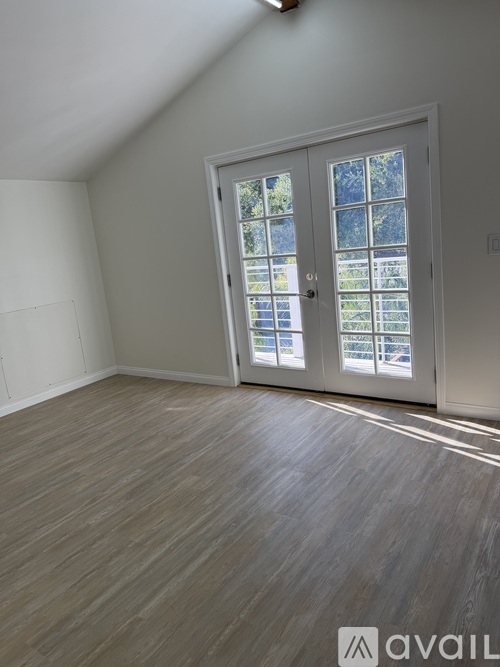 A room with a large door and a window.