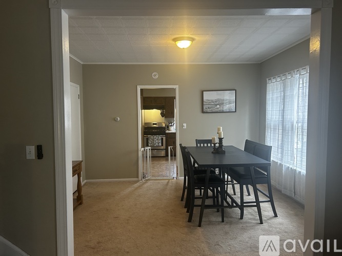 A dining room with a table and chairs is shown.