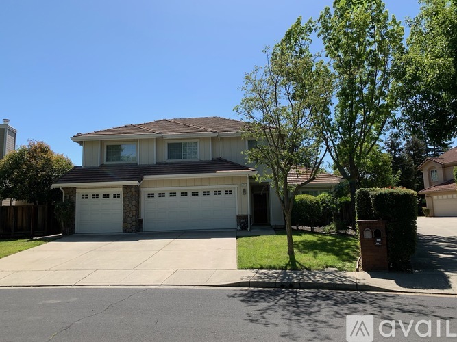 A house with a brown roof and a white garage door.