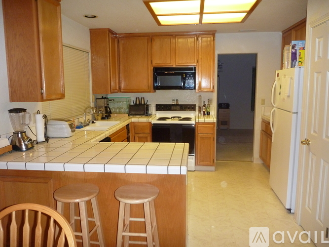 A kitchen with wooden cabinets and a white countertop.