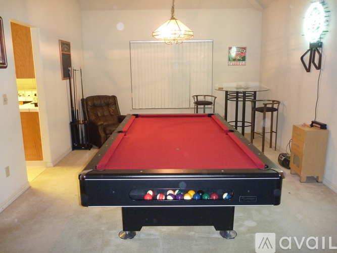 A pool table with a red cloth and a white net in the middle.