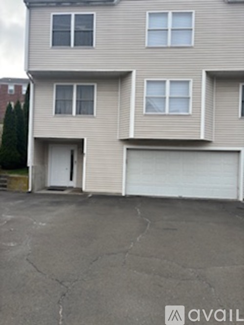 A grey building with a white garage door.