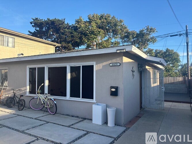 A house with a bicycle parked in front.