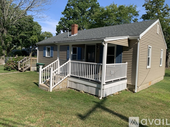 A small house with a porch and a covered deck.
