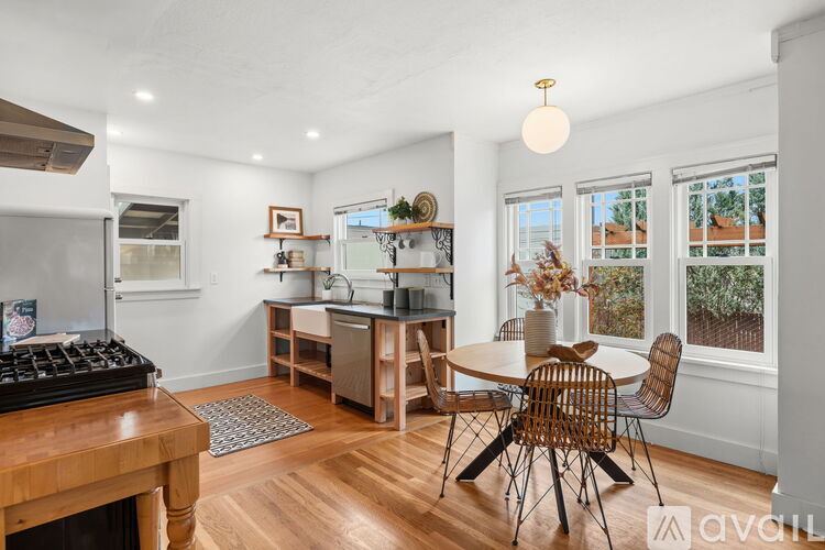 A dining room with a wooden table and chairs.
