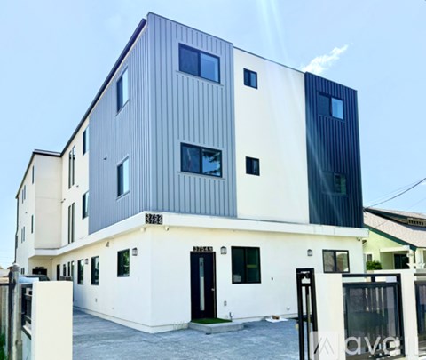 A modern two-story building with a combination of white and dark grey exterior.