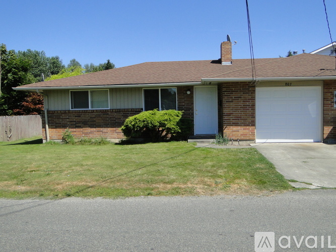 A house with a brown roof and a white garage door.