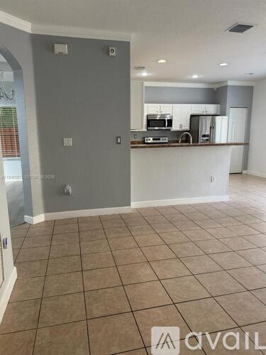 A kitchen area with a counter and cabinets.