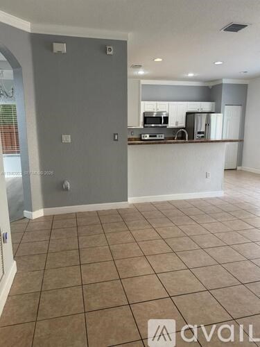 A kitchen area with a counter and cabinets.