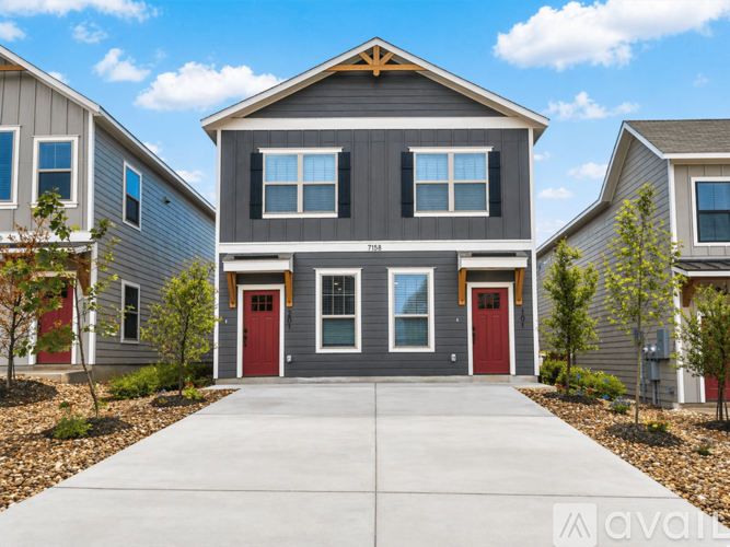 A row of houses with the middle one being the largest.