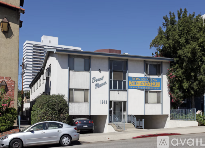 A white building with a sign that says "Now Open" on the front.