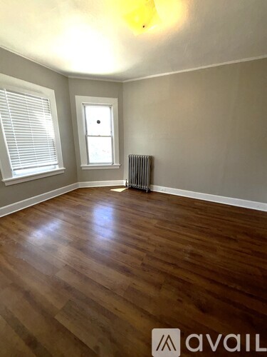 A room with wooden floors and a window.
