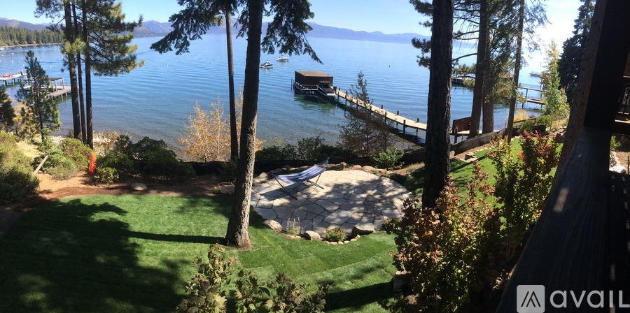 A view of a lake from a house with a dock.